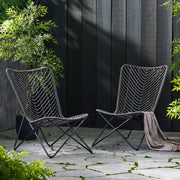 Set of two gray outdoor wicker chairs with geometric cross metal bases by Noble House, perfect for patio or garden seating.