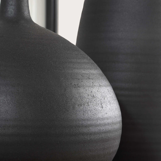 Set of two black Uttermost Bower vases with sleek, modern design, ideal for decorative display or floral arrangements.