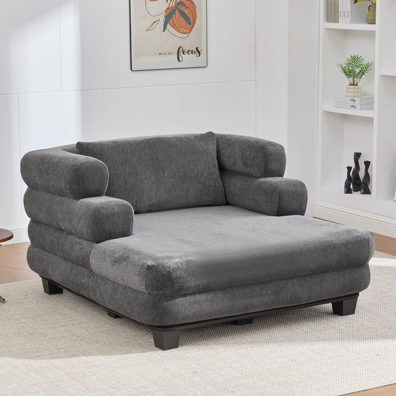 Noble House oversized chaise lounge sofa bed with deep seat and layered armrests, upholstered in neutral fabric.