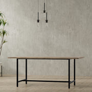 Simpli-Home Campbell handcrafted dining table with a wooden surface and sturdy legs, perfect for family meals and gatherings.