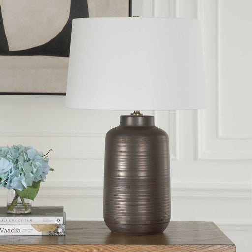 Uttermost Calderone bronze table lamp with a sleek, modern design and a cylindrical base, perfect for contemporary home decor.