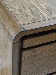 Brown Jensworth Accent Table by Signature Design Ashley, featuring a sleek round top and modern wooden legs.