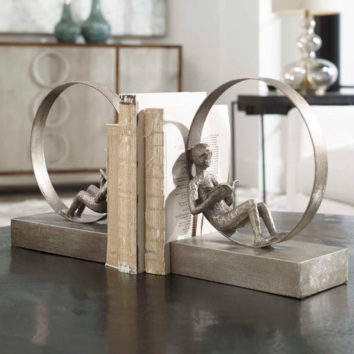 Pair of dark brown antique bookends by Uttermost, featuring intricate design and sturdy construction for holding books upright.