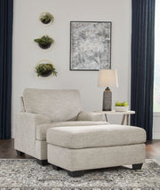 Signature Design by Ashley Vayda living room set with stationary chair and ottoman, featuring plush upholstery and modern style.