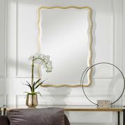 Gold scalloped accent mirror by Uttermost, featuring a decorative frame with elegant curves and intricate design details.