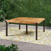 Modern industrial dining table by Noble House with acacia wood slats and teak finish, showcasing a sturdy, stylish design.