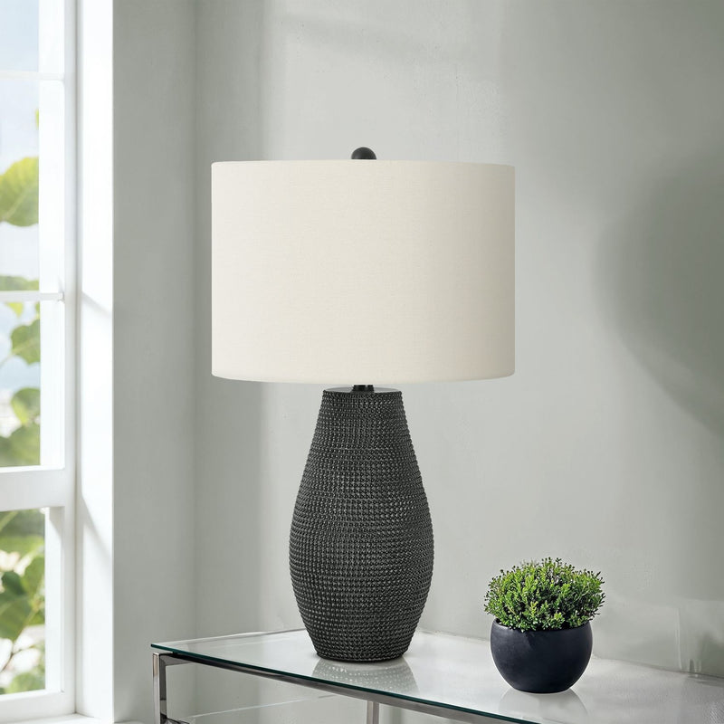 Contemporary black resin table lamp by 8th Street with sleek modern design, perfect for living room or bedside lighting.
