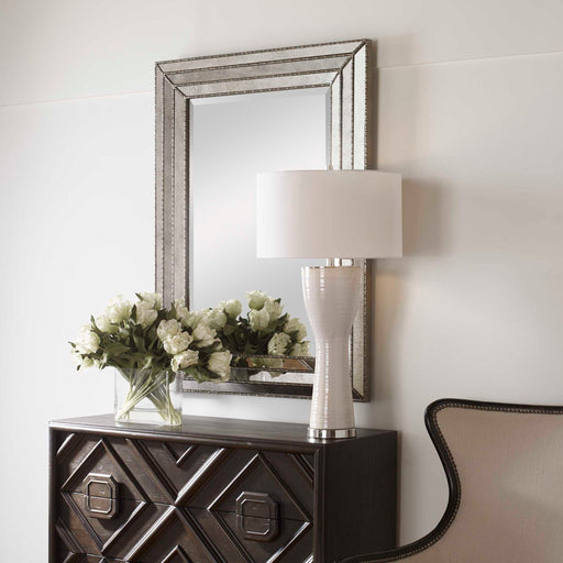 Uttermost Seymour wall mirror in antique silver with a sleek, modern frame and reflective glass, suitable for contemporary decor.