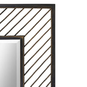 Uttermost Karel Chevron Wall Mirror with black frame, geometric chevron design, hanging on a wall for modern decor.