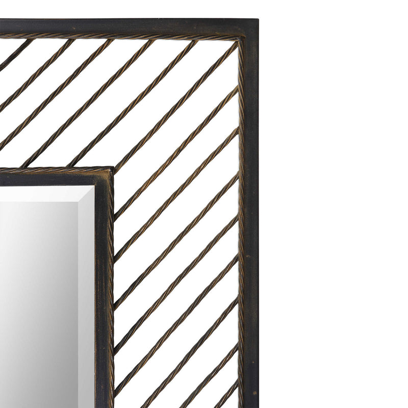 Uttermost Karel Chevron Wall Mirror with black frame, geometric chevron design, hanging on a wall for modern decor.