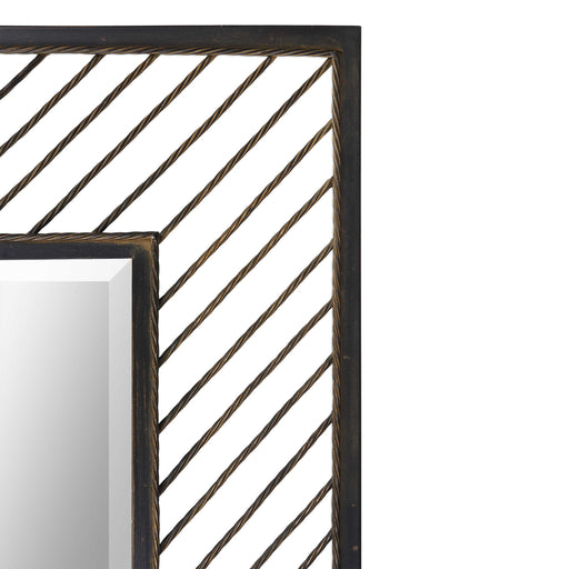 Uttermost Karel Chevron Wall Mirror with black frame, geometric chevron design, hanging on a wall for modern decor.