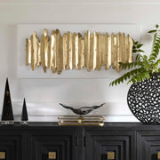 White and gold metal wall decor by Uttermost featuring an intricate, modern design for stylish interior wall decoration.
