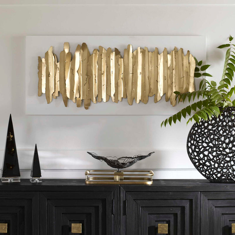 White and gold metal wall decor by Uttermost featuring an intricate, modern design for stylish interior wall decoration.