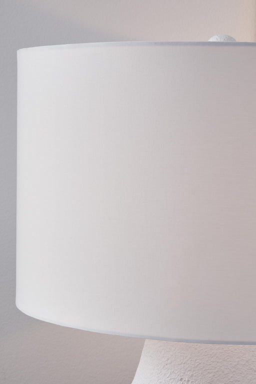 White and navy metal table lamp from Dashland by Signature Design Ashley, featuring a sleek modern design with a cylindrical base.