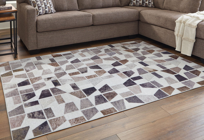 Signature Design by Ashley Jettner area rug with geometric pattern in neutral tones, ideal for living room or bedroom decor.