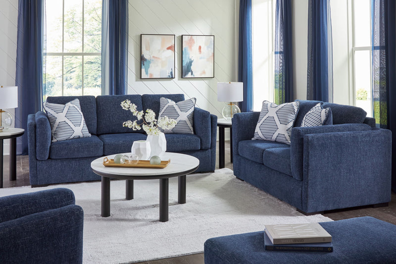 Benchcraft Evansley living room set with stationary chair and matching ottoman, upholstered in neutral fabric.