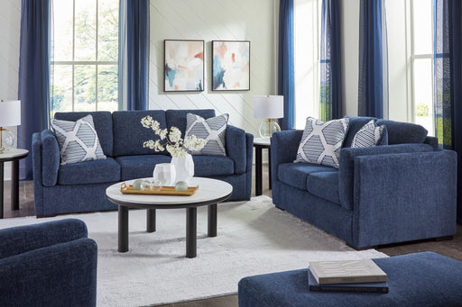 Benchcraft Evansley living room set with stationary chair and matching ottoman, upholstered in neutral fabric.