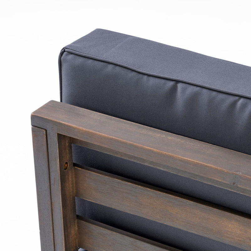 Noble House outdoor acacia wood patio arm chair with fabric cushion, showcasing a sturdy wooden frame and comfortable seating.