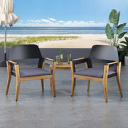 Set of two Noble House Soho outdoor club chairs with teak frames and cushions, perfect for transitional style patio seating.