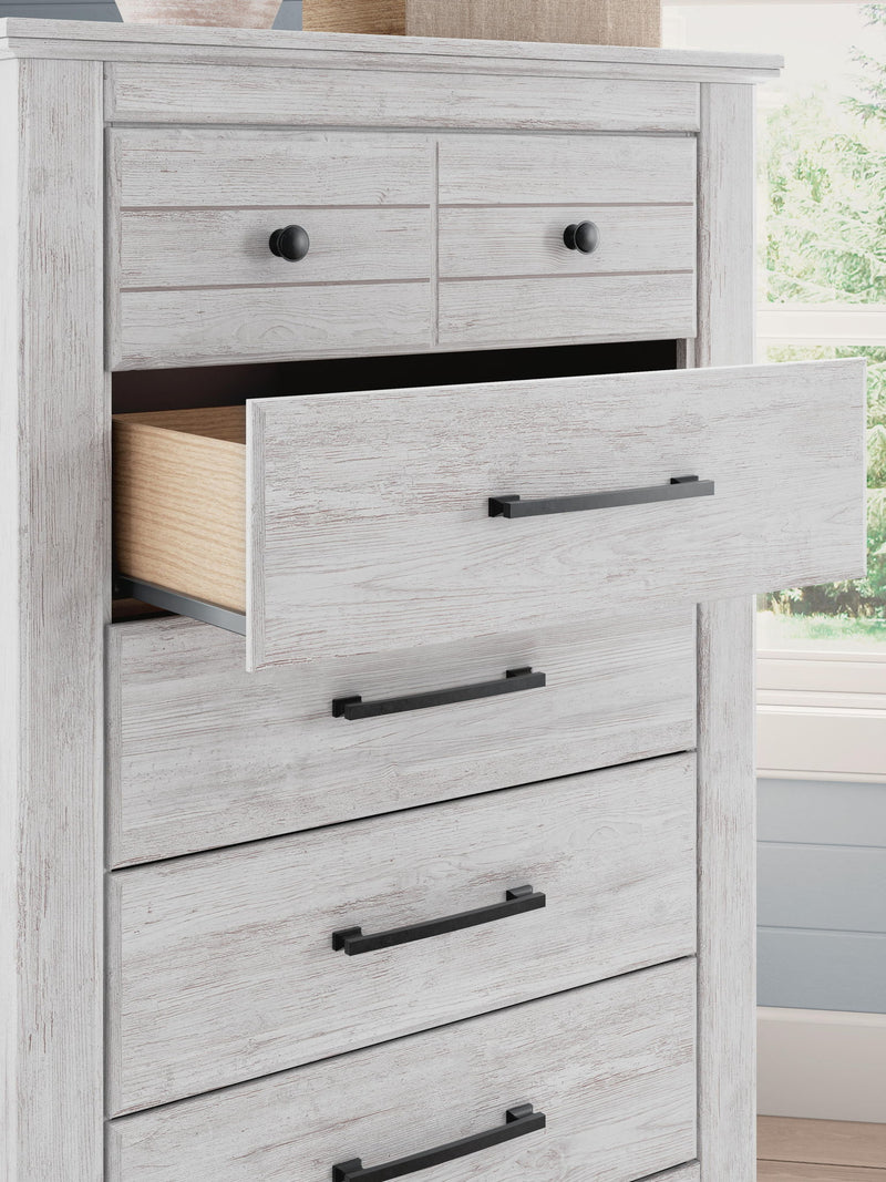 Signature Design by Ashley Makidern five-drawer accent chest with wood finish and sleek metal handles, showcasing its stylish storage design.