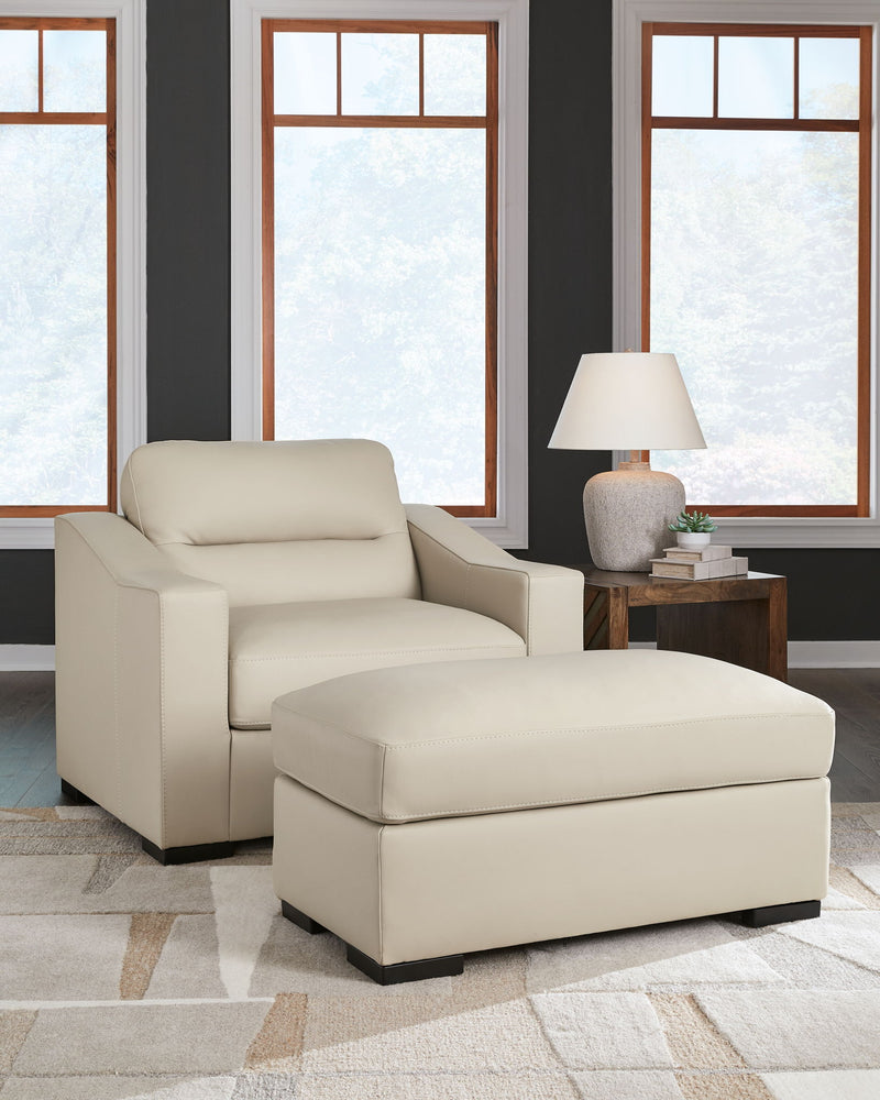 Signature Design Ashley Treasure Trove 2-piece chair and ottoman set with almond upholstery, stationary chair and matching ottoman.