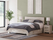 Signature Design by Ashley Lawroy panel bed with built-in storage drawers in a modern bedroom setting.