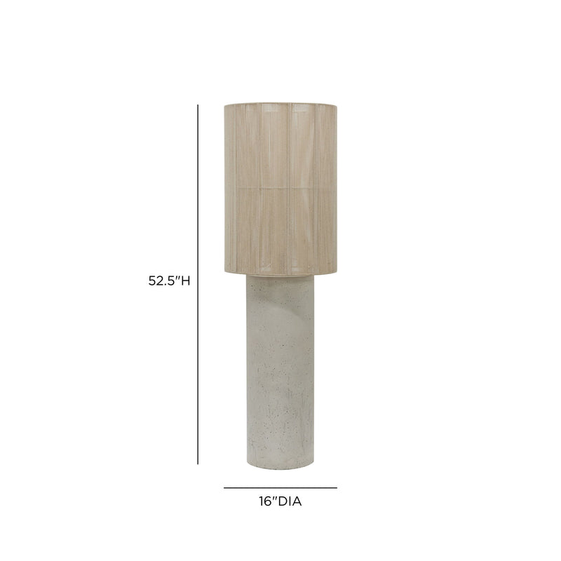 TOV Furniture Mondada concrete floor lamp with a sleek, modern design and cylindrical shape standing on a wooden floor.