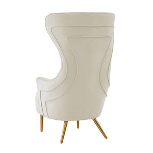 TOV Furniture Jezebel velvet wingback chair with high backrest and elegant design, showcasing plush fabric and sturdy wooden legs.