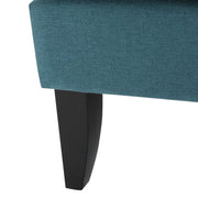 Noble House Serenada upholstered fabric arm chair with nailhead trim and tapered birch wood legs, in a cozy living room setting.