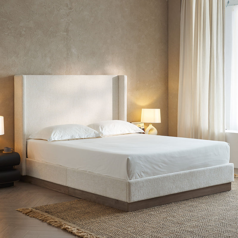 House & Home Furniture Hosford minimalist upholstered wingback bed with wood base platform, showcasing the sleek headboard and sturdy frame.