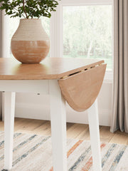 Round dining table with drop leaf design by Signature Design by Ashley, featuring a polished wood finish and sturdy legs.