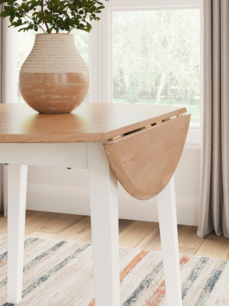 Round dining table with drop leaf design by Signature Design by Ashley, featuring a polished wood finish and sturdy legs.