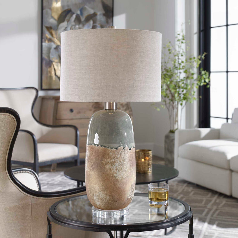 Light brown ceramic table lamp by Uttermost with a smooth, rounded base and a fabric shade for elegant lighting.