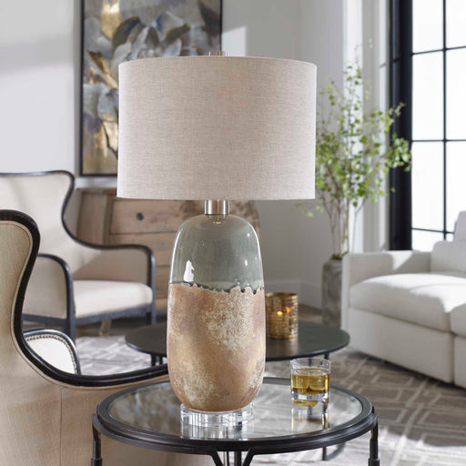 Light brown ceramic table lamp by Uttermost with a smooth, rounded base and a fabric shade for elegant lighting.