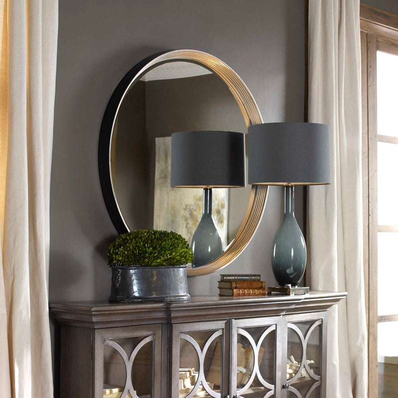 Uttermost Serenza round wall mirror with silver frame, reflecting a modern design for stylish home decor.