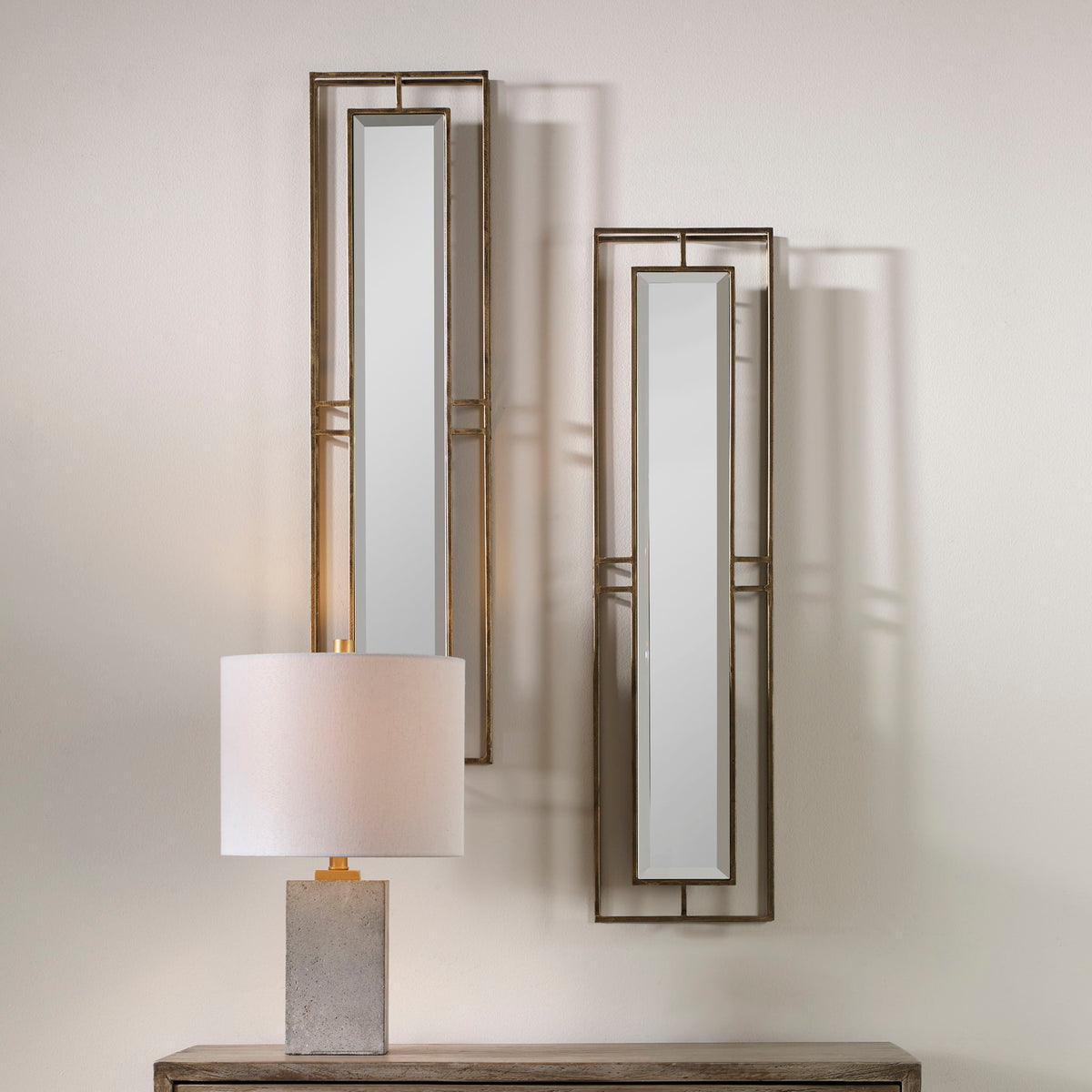 Pair of gold wall mirrors from the Rutledge set by Uttermost, featuring elegant round frames with a polished gold finish.