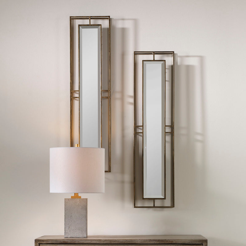 Pair of gold wall mirrors from the Rutledge set by Uttermost, featuring elegant round frames with a polished gold finish.