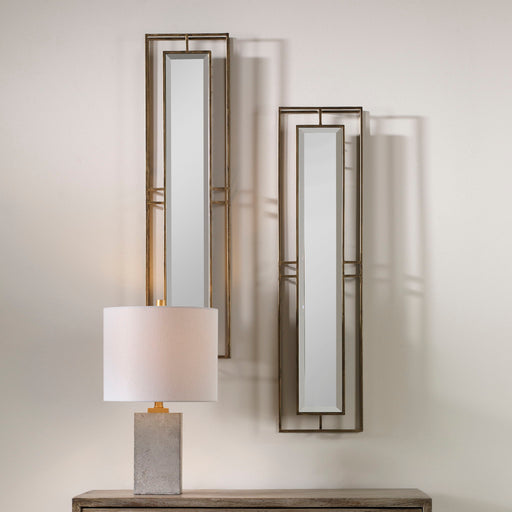 Pair of gold wall mirrors from the Rutledge set by Uttermost, featuring elegant round frames with a polished gold finish.