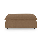 Classic Home Caplan upholstered ottoman with tufted fabric and wooden legs, versatile for living room or bedroom decor.