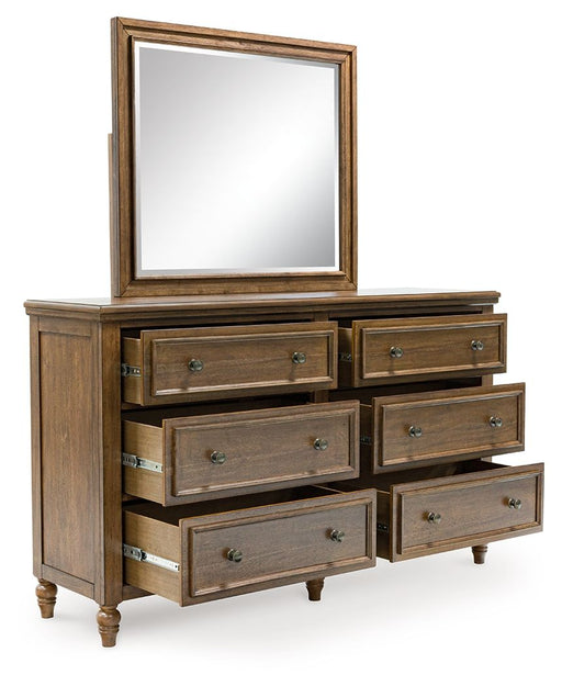 Benchcraft Sturlayne 6-piece bedroom set with a panel bed, dresser, mirror, and nightstands in a modern bedroom decor.