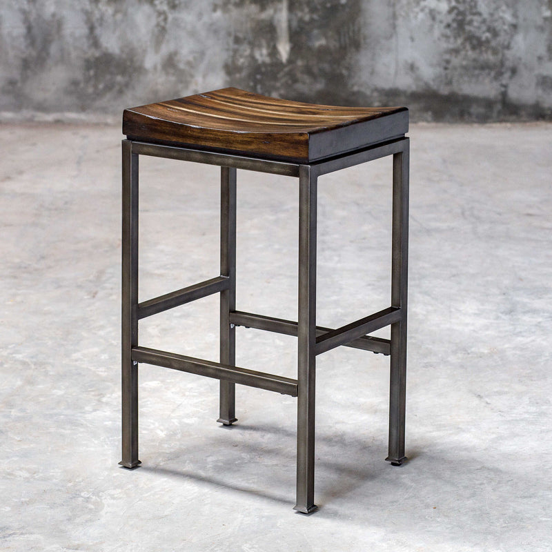 Beck industrial counter height bar stool by Uttermost with metal frame and wooden seat, suitable for kitchen or bar area.
