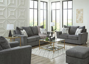 Signature Design by Ashley living room set with stationary chair and matching ottoman, featuring plush upholstery and modern style.