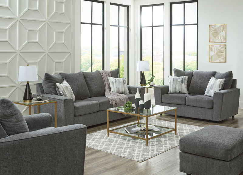Signature Design by Ashley living room set with stationary chair and matching ottoman, featuring plush upholstery and modern style.
