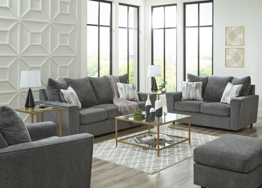 Signature Design by Ashley living room set with stationary chair and matching ottoman, featuring plush upholstery and modern style.