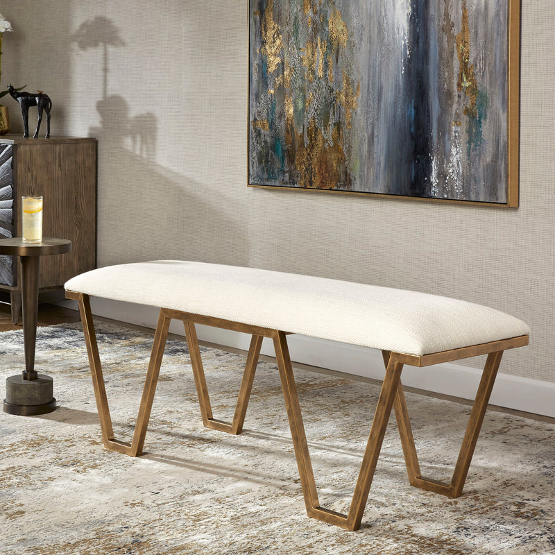 White geometric accent bench by Uttermost with angular metal legs and a modern design, ideal for stylish entryways or living spaces.