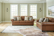 Signature Design by Ashley Carianna living room set with stationary chair and ottoman, featuring plush upholstery and modern style.