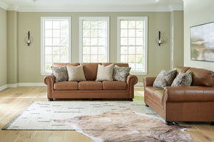 Signature Design by Ashley Carianna living room set with stationary chair and ottoman, featuring plush upholstery and modern style.