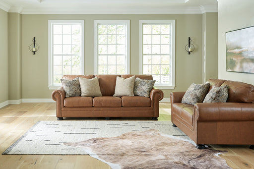 Signature Design by Ashley Carianna living room set with stationary chair and ottoman, featuring plush upholstery and modern style.