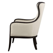 Uttermost Sandy wing back armchair in beige and dark brown fabric with plush cushioning and wooden legs.
