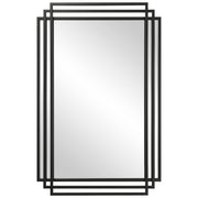 Uttermost Amherst wall mirror with a sleek, modern frame hanging on a wall, showcasing its stylish design and reflective surface.